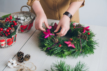 Florist decorator making Christmas wreath