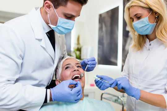 Beautiful senior woman receiving a dental treatment.