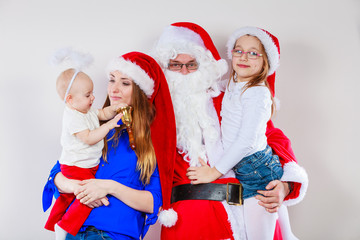 Mother, Santa and two daughters christmas family photo