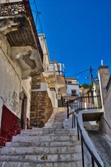Fototapeta na wymiar A stairway on a small alley in Pothia, Kalymnos, Greece