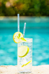 Water with ice at the edge of a resort pool. Concept of luxury vacation