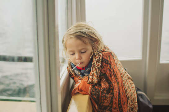 Little girl sitting inside vintage steam boat
