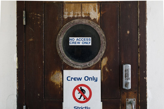 A "No access, crew only" sign on a door on the deck of a boat" "No access, crew only" sign on a door on the deck of a bo""No access, crew only" sign on a door on the deck of a b"No access, crew only" sign on a door on the deck of a b"o access, crew only" sign on a doo" access, crew