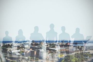 Composite image of colleagues standing over white background