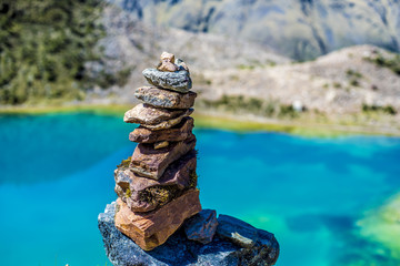 pile of stones and blue lake at the background. New Zealand