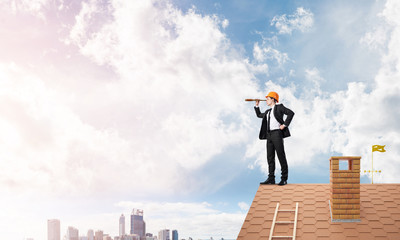 Engineer man standing on roof and looking in spyglass. Mixed media