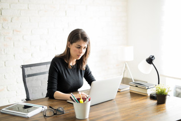 Latin woman working on her computer