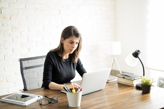 Latin woman working on her computer