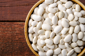 White kidney bean in bowl on wooden background. Horizontal