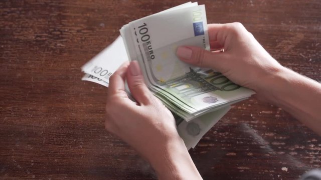 A woman's hands counting 2k euros. 4K. Without post-editing