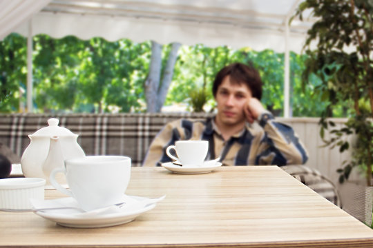 people, drinks and dating concept - close up of couple drinking tea at cafe. A date a look from the girl's side. Boredom, communication difficulties, unsuccessful date.