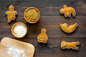 Make gluten free healthy food. Yoga asanas cookies near desk, flour and wheat on dark wooden...