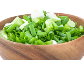 sliced onion leaf in wooden bowl
