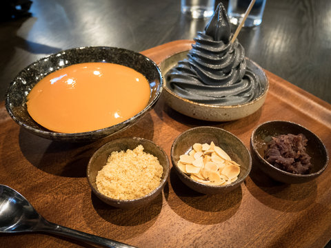 Mochi and ice cream eaten with red beans, sugar, almonds. In a wooden cup Put on the table.Mizu Shingen Mochi