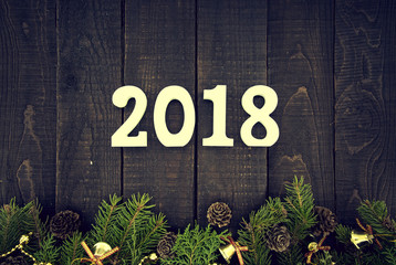 Composition with decorated Christmas tree and number 2017 as a symbol of the coming New Year on a rustic wooden background. Holiday greeting card. Top view