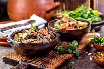 Chilean Ajiaco. Latin American food. Ajiaco - traditional chilean soup with grilled meat, onion and potato served in clay plates