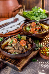 Chilean Ajiaco. Latin American food. Ajiaco - traditional chilean soup with grilled meat, onion and potato served in clay plates