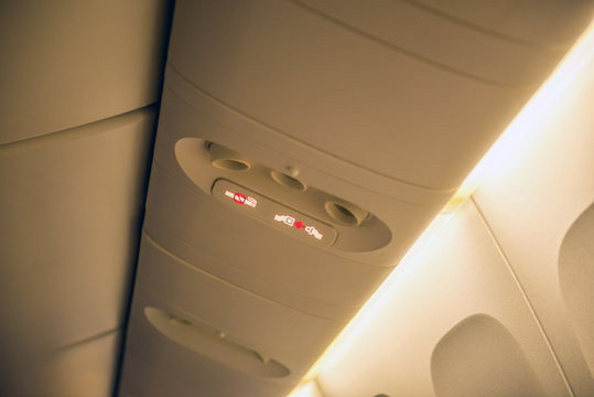 Fasten seat belt sign on a plane and no smoking sign on airplane,Selective focus