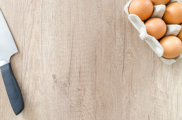 Eggs with knife on wood table