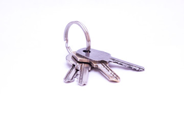 Four keys fixed with a keyring isolated on white background