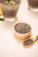 Selective focus of chia seeds drink with water in transparent glass with lemon balm.
