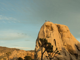 Rock climbers on top of a Hidden Valley boulder, Joshua Tree National Park