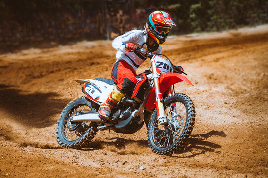 Close-up of mountain motocross race in dirt track in day time. Concept focus of during an acceleration in action sport