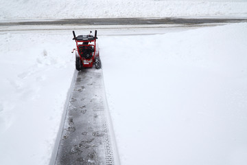 snow blower removing snow on the driveway