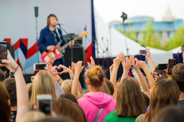 Audience cheering musicians at an open air music festival