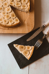 divisively useful tartan with cottage cheese and bananas on a white wood table
