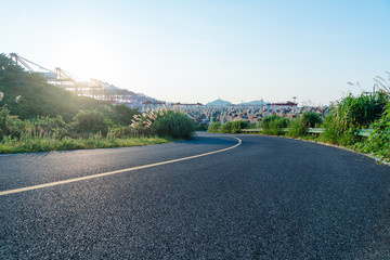 empty highway with an industrial port on background,china.