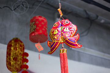Chinese luck charm of red color hanging on a Christmas tree