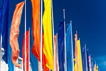 Colourful flags against the blue sky