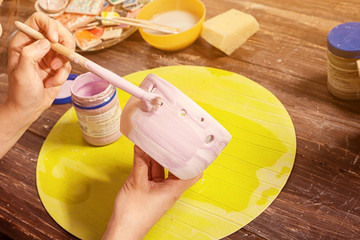 potter paints a clay