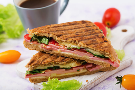 Club sandwich panini with ham, tomato, cheese and lettuce