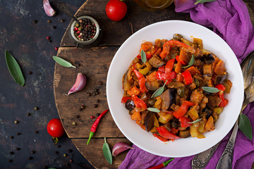 Hot spicy stew eggplant, sweet pepper, tomato and capers. Flat lay. Top view