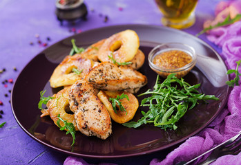 Chicken fillet with apples cooked on grill.