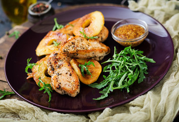 Chicken fillet with apples cooked on grill.