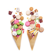 Sweets in waffle cones on white background