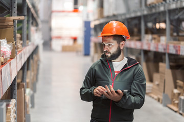 wholesale, logistic, people and export concept - manager or supervisor with tablet at warehouse