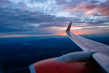 sun set twilight time on airplane,dramatic cloud