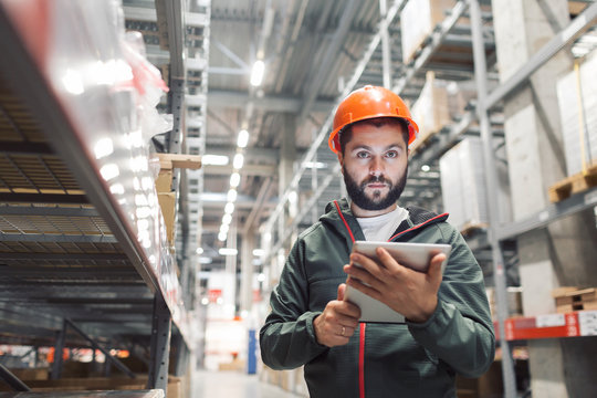 wholesale, logistic, people and export concept - manager or supervisor with tablet at warehouse