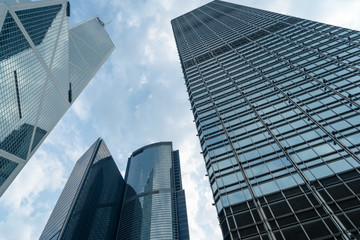 Fototapeta na wymiar directly below of modern financial skyscrapers in central Hong Kong,blue toned,china.