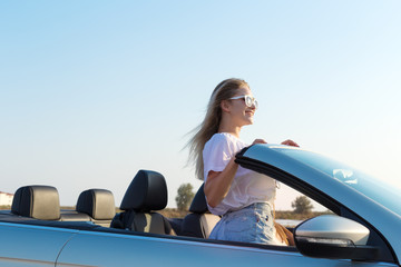 Two attractive young women in a cabriolet car