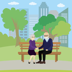 Old couple of people sitting on a bench in the park