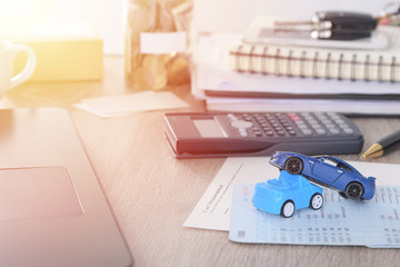 Car insurance concept:Car claim form with car toy crash on desk