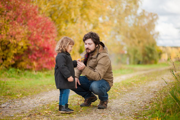 Fototapeta premium Father and daughter walking together, autumn day.