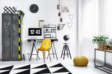 Yellow pouf in designer workspace