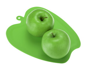 Green apples lying on plastic chopping board