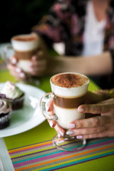woman hands holding Latte art, coffee cup.